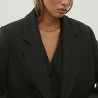 Double-breasted woolen jacket in a gray-green stripe