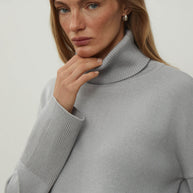 Knitted sweater with a voluminous neck