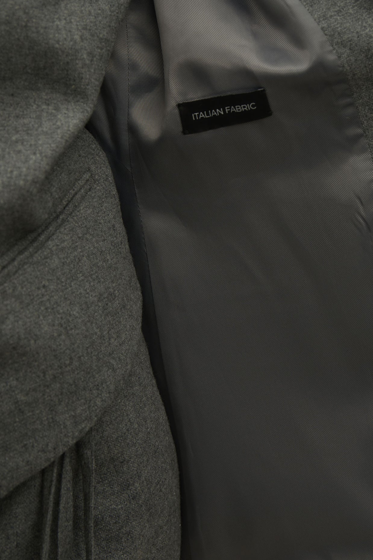 Single-breasted woolen jacket with a tie in gray